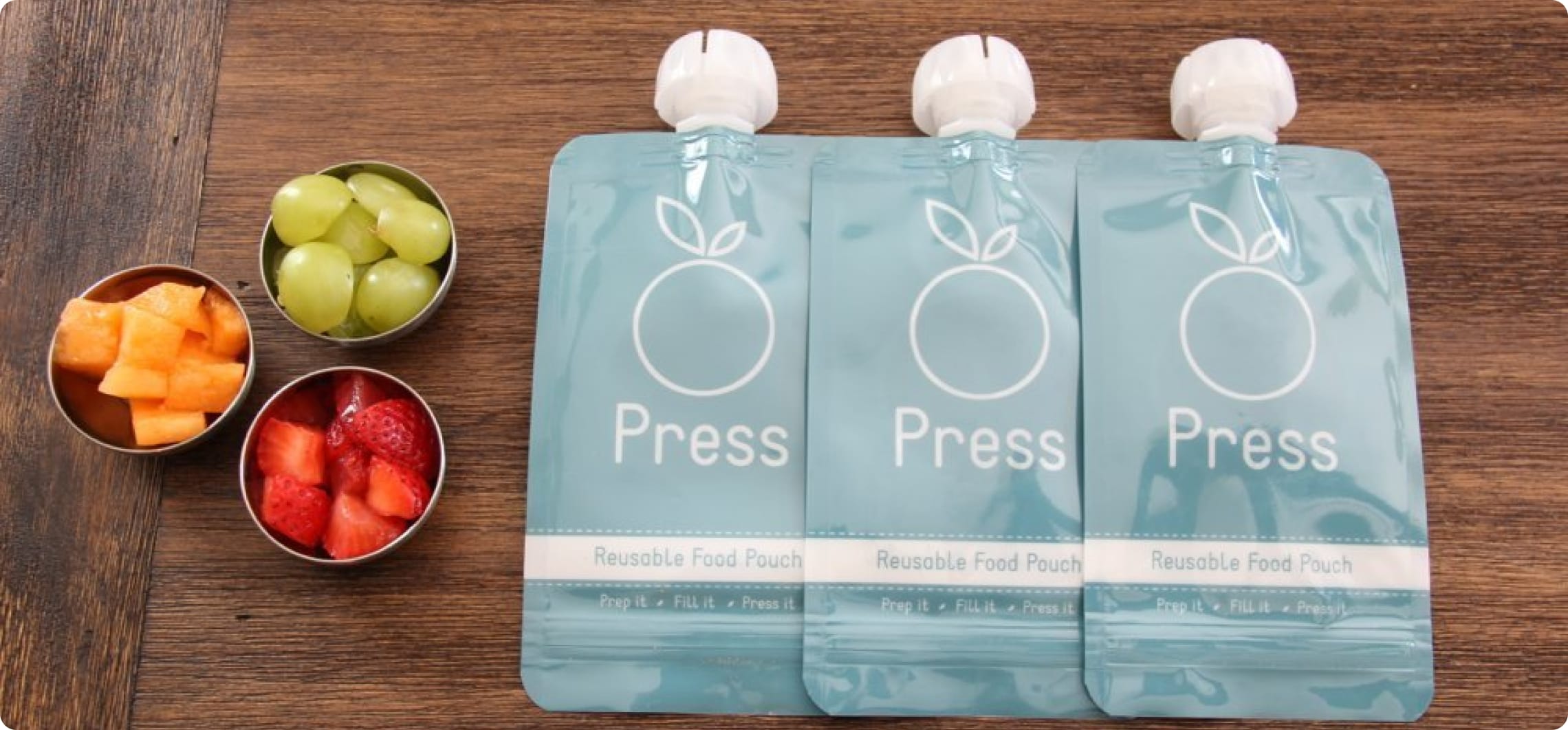 three press baby food pouches on table