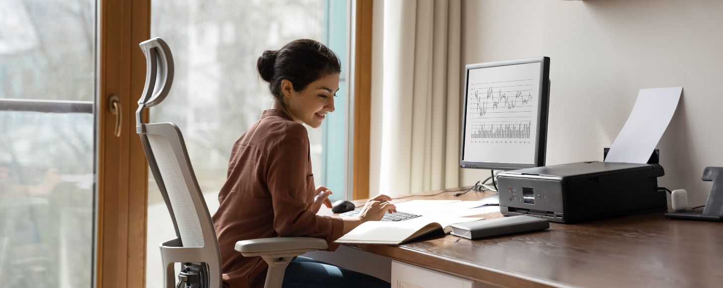 woman reviewing analytics on desktop computer