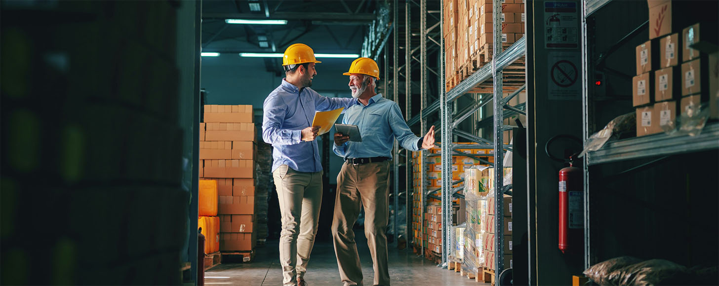 two gentleman inspecting warehouse