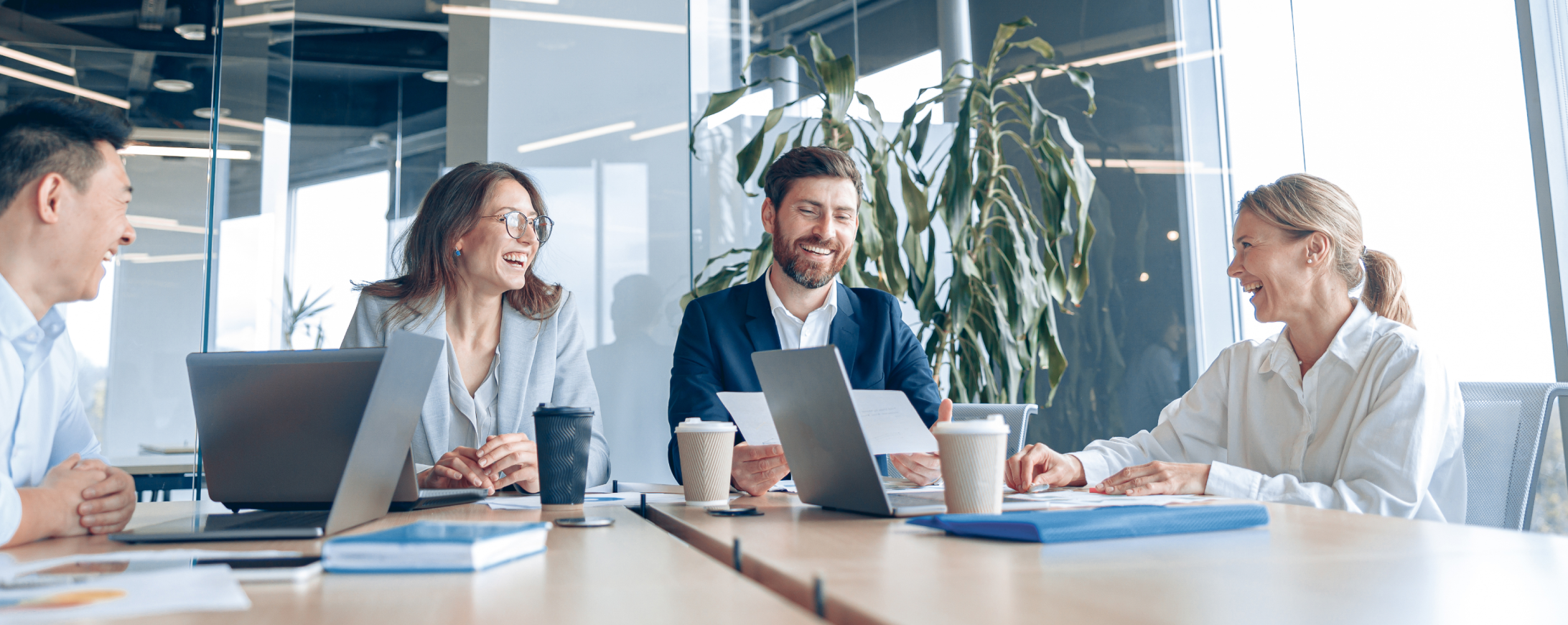 advisory team smiling in a modern conference room, discussing growth strategy and digital marketing